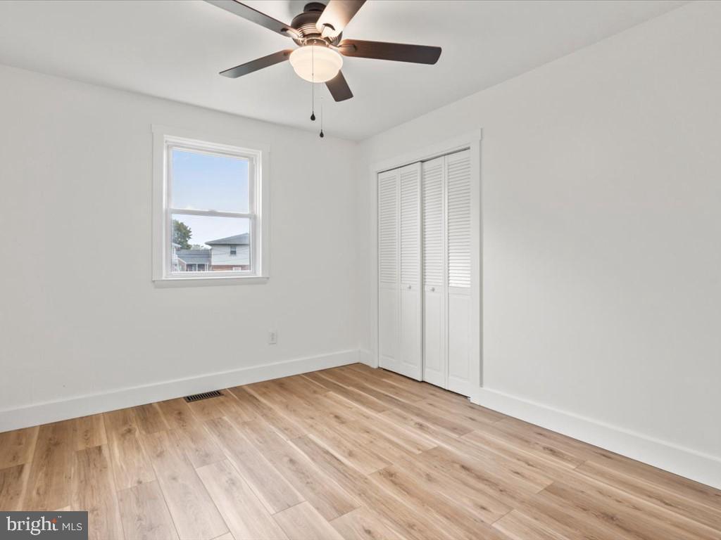 1310 Delaware Lane, Unit A Hagerstown, MD 21740 - Photo 13 of 24 wooden floor in an empty room with a window