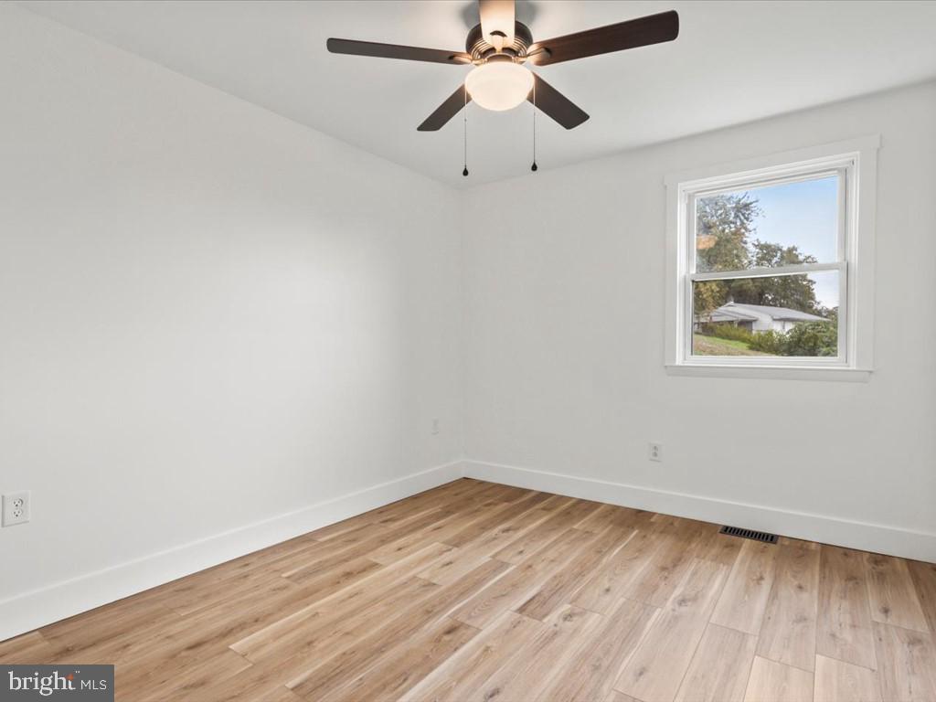 1310 Delaware Lane, Unit A Hagerstown, MD 21740 - Photo 15 of 24 an empty room with a window and wooden floor