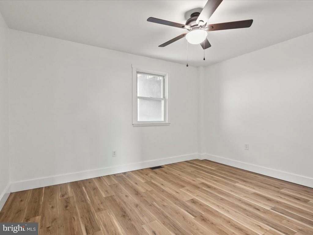 1310 Delaware Lane, Unit A Hagerstown, MD 21740 - Photo 16 of 24 an empty room with a window and a ceiling fan