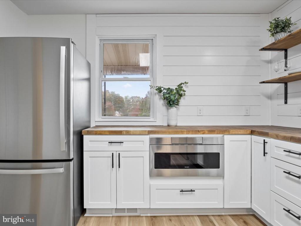 1310 Delaware Lane, Unit A Hagerstown, MD 21740 - Photo 3 of 24 a kitchen with granite countertop white cabinets and white appliances