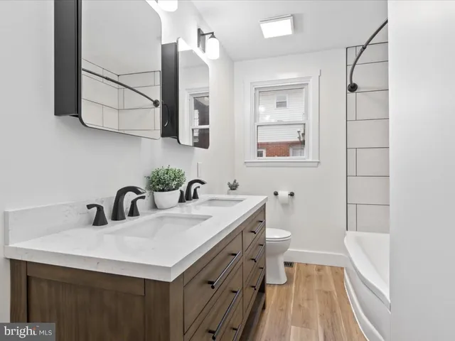 a bathroom with a sink a toilet and mirror