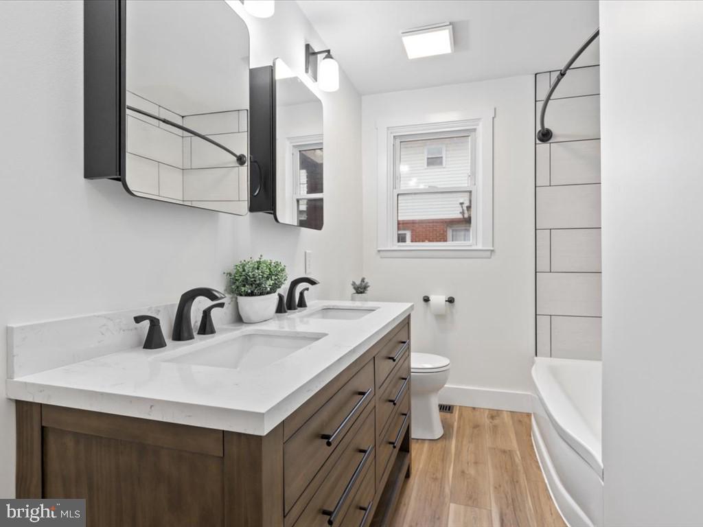 1310 Delaware Lane, Unit A Hagerstown, MD 21740 - Photo 4 of 24 a bathroom with a sink a toilet and mirror