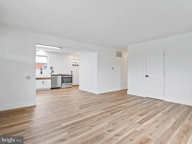 a view of a kitchen with wooden floor and a sink