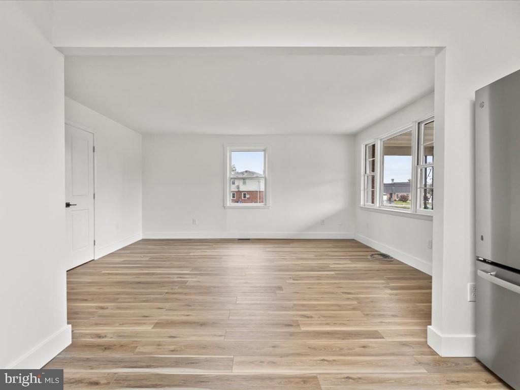 1310 Delaware Lane, Unit A Hagerstown, MD 21740 - Photo 10 of 24 a view of an empty room with wooden floor and a window
