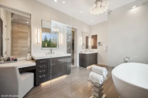 a spacious bathroom with a bathtub sink and mirror