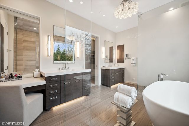 a spacious bathroom with a bathtub sink and mirror