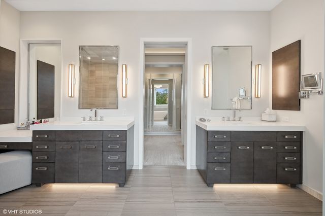 a spacious bathroom with double vanity and a double vanity sink mirror