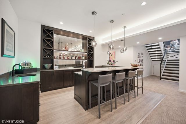 a kitchen with stainless steel appliances kitchen island granite countertop a sink and cabinets