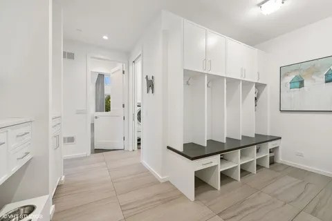 a living room with furniture a rug and white walls