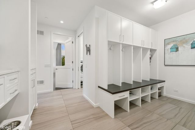 a living room with furniture a rug and white walls