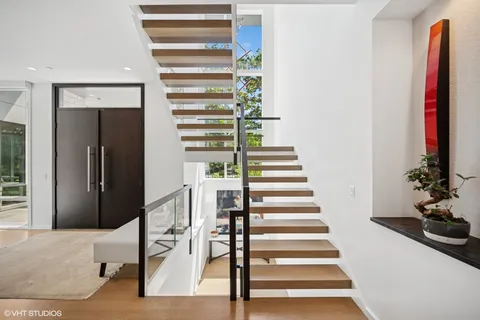 a view of entryway with wooden floor and stairs