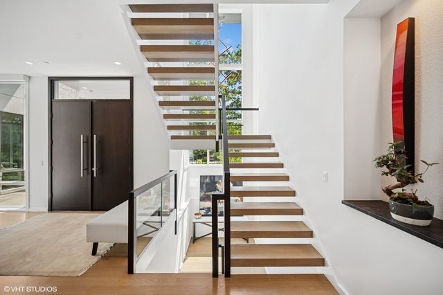 a view of entryway with wooden floor and stairs
