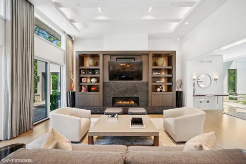 a living room with furniture and large window