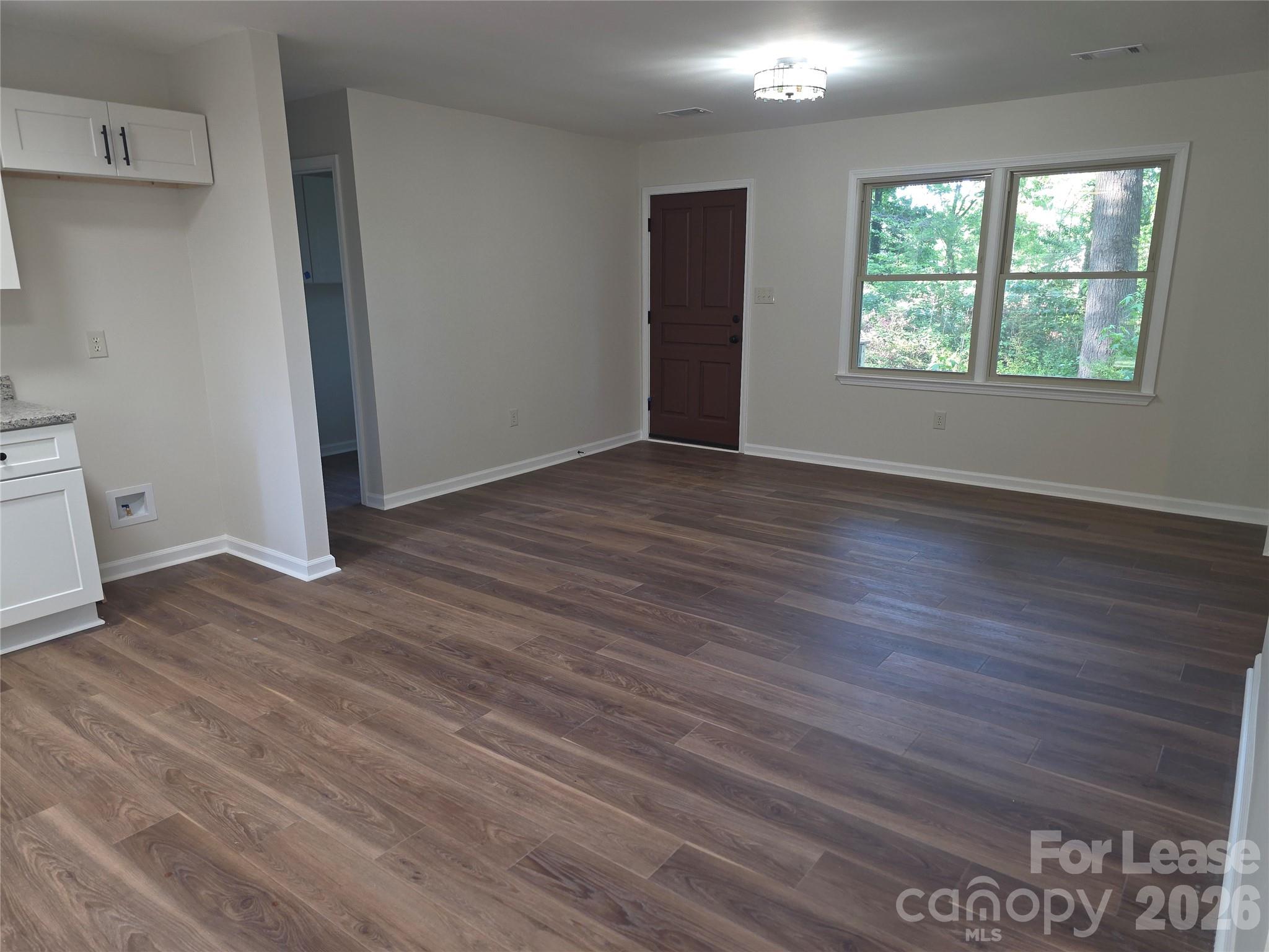5710 Unionville Road Monroe, NC 28110 - Photo 6 of 18 an empty room with wooden floor and windows