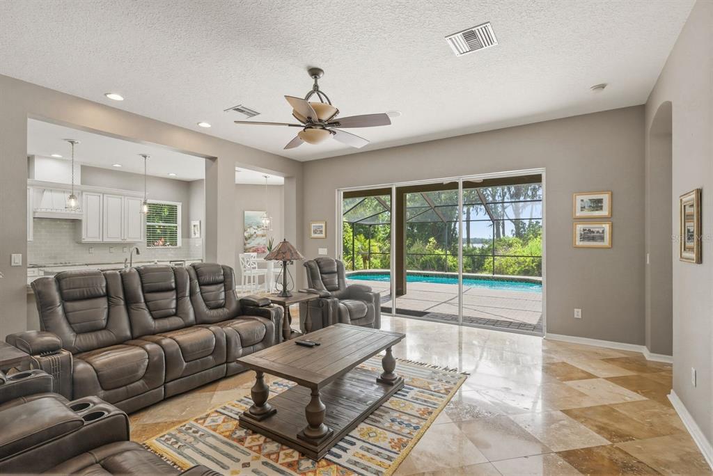9103 Creedmoor Lane New Port Richey, FL 34654 - Photo 16 of 90 a living room with furniture and a large window