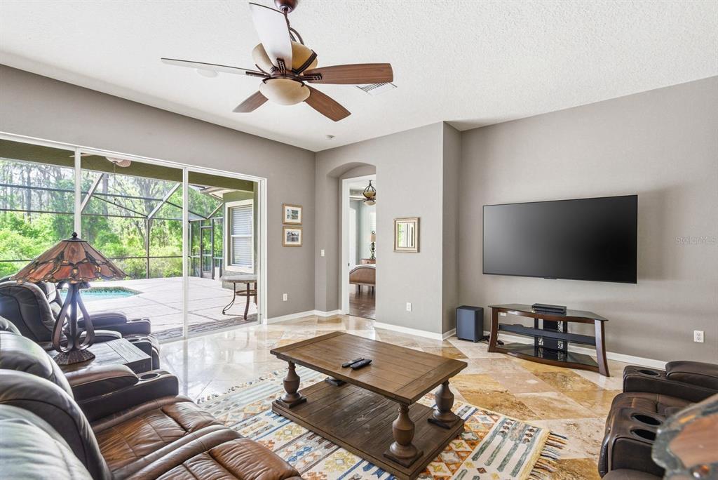 9103 Creedmoor Lane New Port Richey, FL 34654 - Photo 17 of 90 a living room with furniture and a flat screen tv