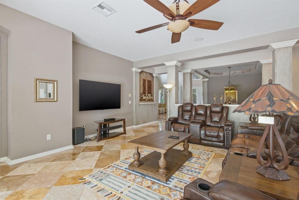 9103 Creedmoor Lane New Port Richey, FL 34654 - Photo 19 of 90 a living room with furniture and a flat screen tv