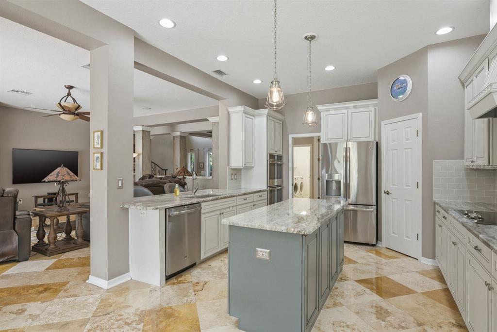 9103 Creedmoor Lane New Port Richey, FL 34654 - Photo 22 of 90 a kitchen with stainless steel appliances granite countertop a sink stove and refrigerator