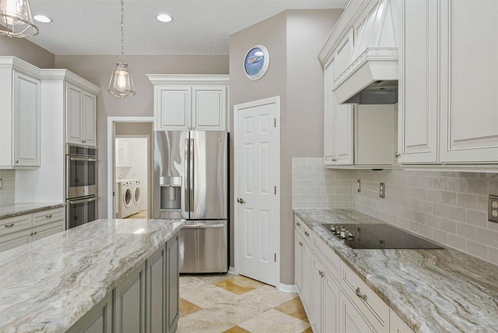9103 Creedmoor Lane New Port Richey, FL 34654 - Photo 23 of 90 a kitchen with stainless steel appliances granite countertop a sink stove and refrigerator