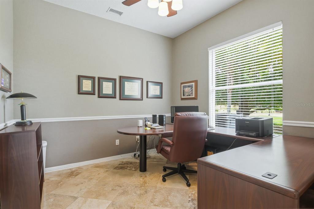9103 Creedmoor Lane New Port Richey, FL 34654 - Photo 27 of 90 a view of a workspace with furniture and a window
