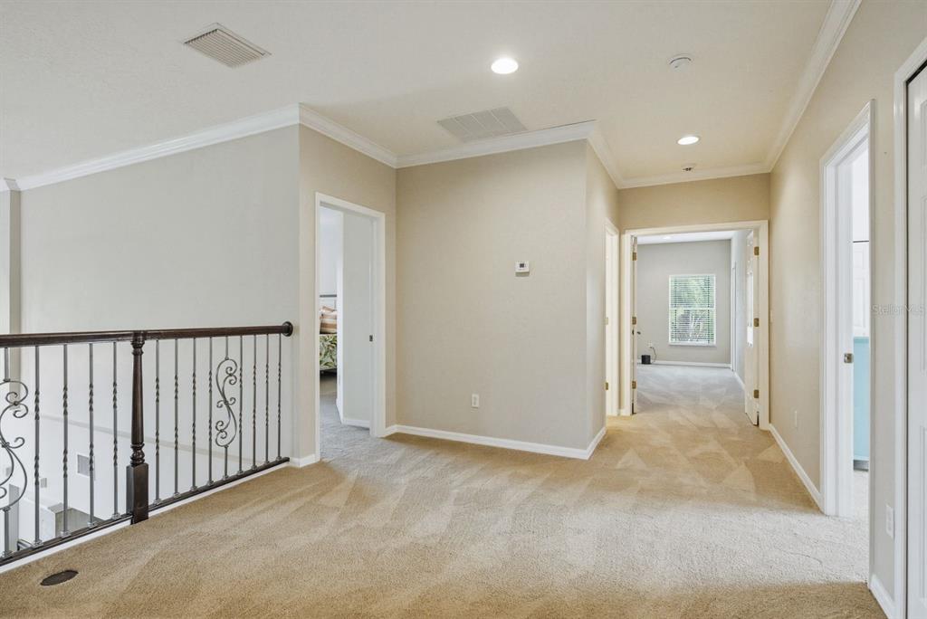 9103 Creedmoor Lane New Port Richey, FL 34654 - Photo 30 of 90 a view of a hallway with wooden floor and bathroom