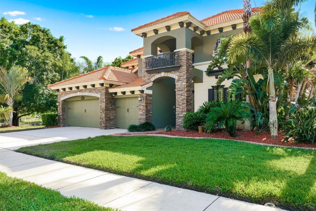 9103 Creedmoor Lane New Port Richey, FL 34654 - Photo 3 of 90 a front view of a house with a yard and garage