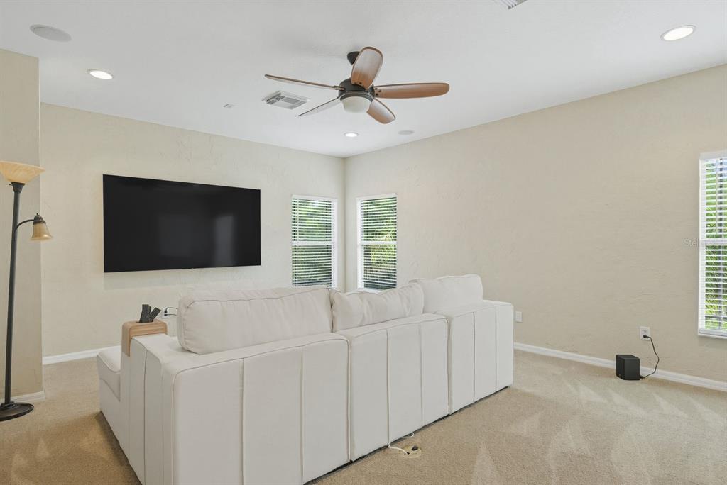 9103 Creedmoor Lane New Port Richey, FL 34654 - Photo 33 of 90 a living room with furniture and a flat screen tv