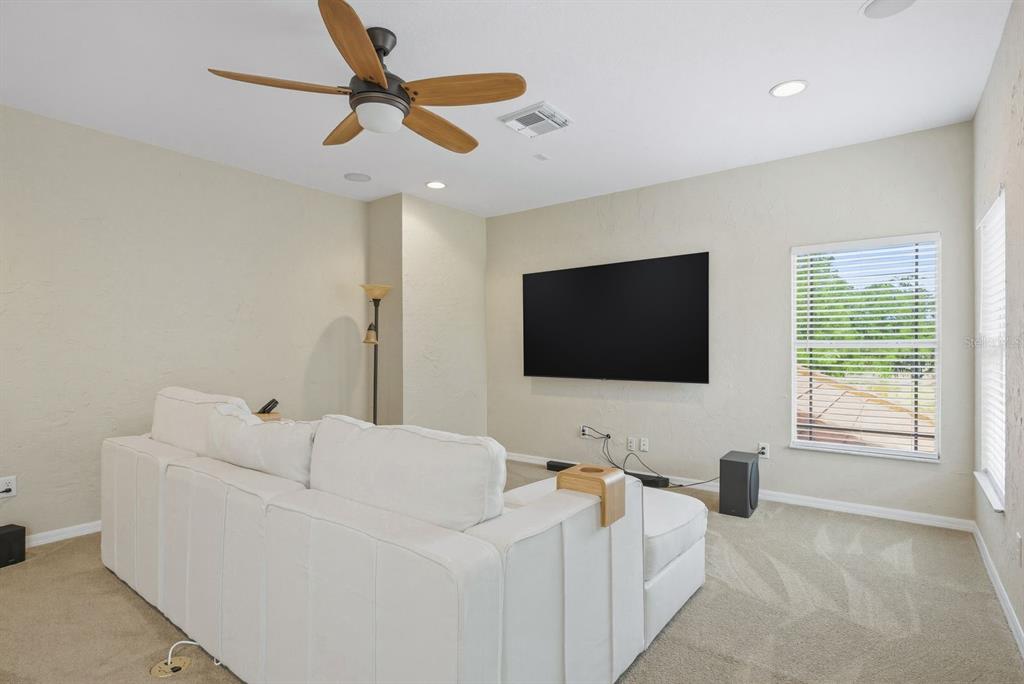 9103 Creedmoor Lane New Port Richey, FL 34654 - Photo 34 of 90 a living room with furniture and a flat screen tv