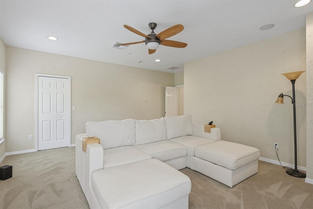 9103 Creedmoor Lane New Port Richey, FL 34654 - Photo 35 of 90 a living room with furniture and a ceiling fan