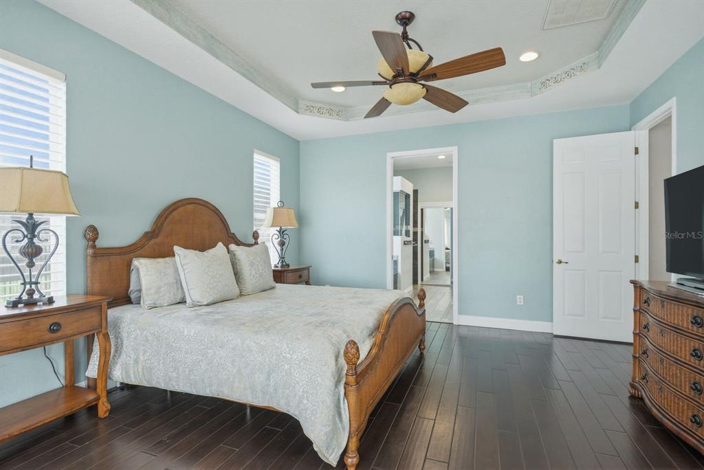 9103 Creedmoor Lane New Port Richey, FL 34654 - Photo 39 of 90 a bedroom with a bed a flat tv screen and a dresser