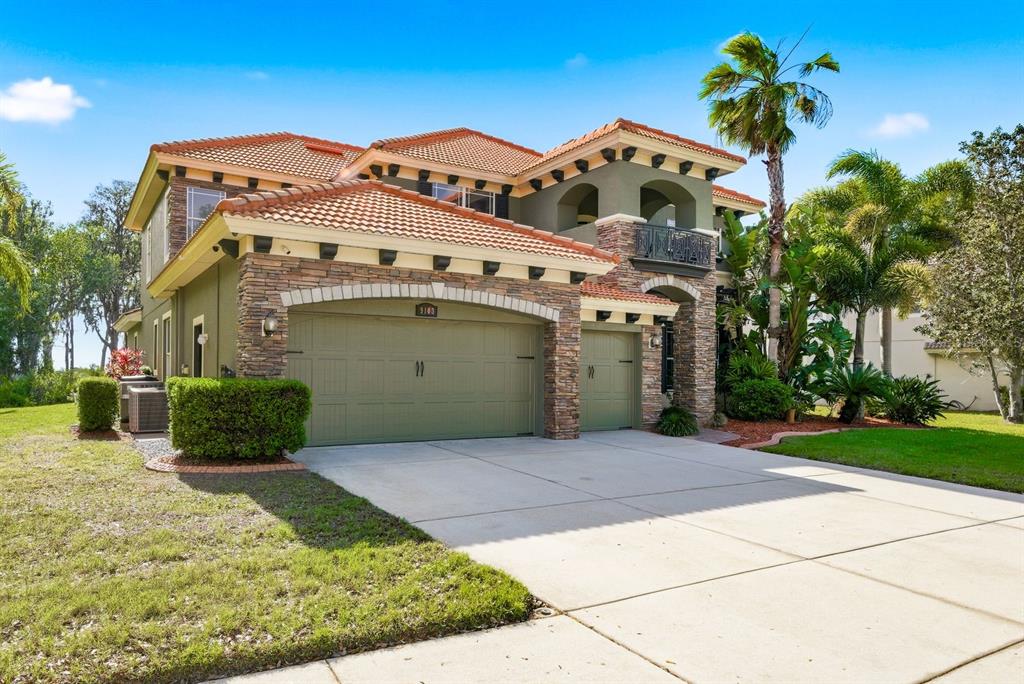 9103 Creedmoor Lane New Port Richey, FL 34654 - Photo 4 of 90 a front view of a house with a yard and garage