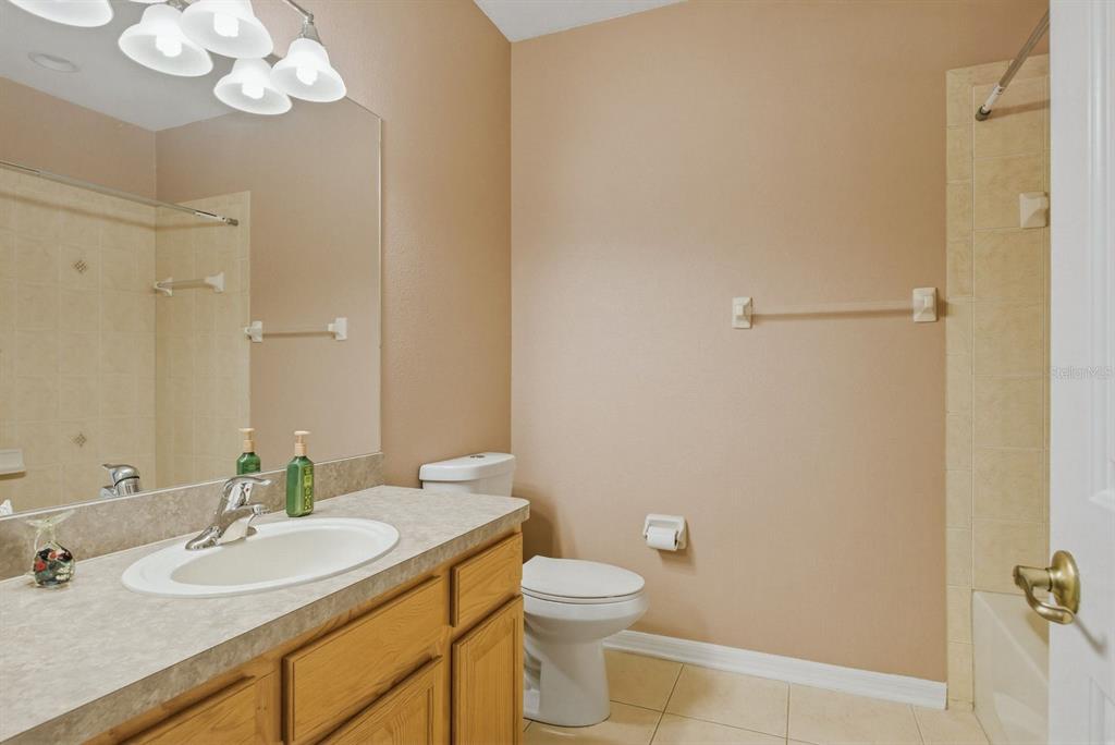 9103 Creedmoor Lane New Port Richey, FL 34654 - Photo 46 of 90 a bathroom with a granite countertop sink a toilet and a mirror