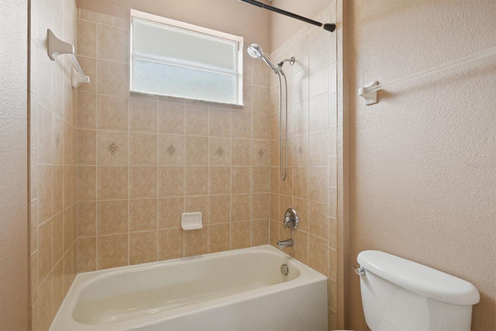 9103 Creedmoor Lane New Port Richey, FL 34654 - Photo 50 of 90 a white bath tub sitting next to a toilet
