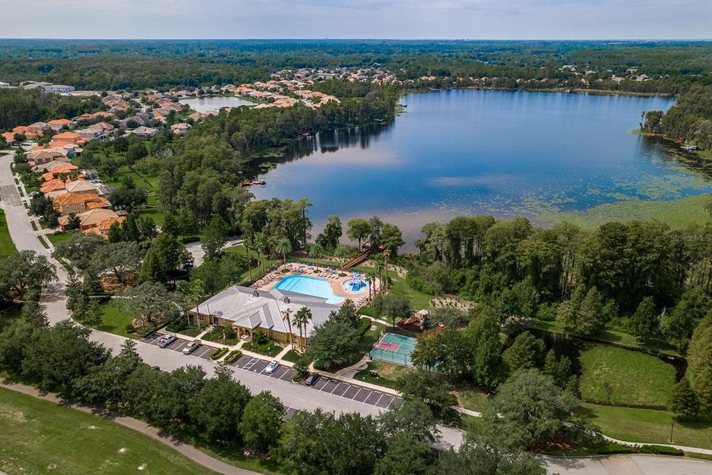 9103 Creedmoor Lane New Port Richey, FL 34654 - Photo 87 of 90 an aerial view of residential houses with outdoor space and lake view