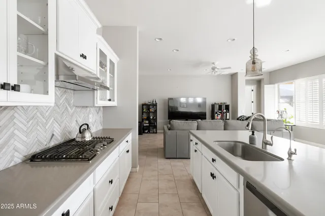 a kitchen with a sink stove top oven and refrigerator