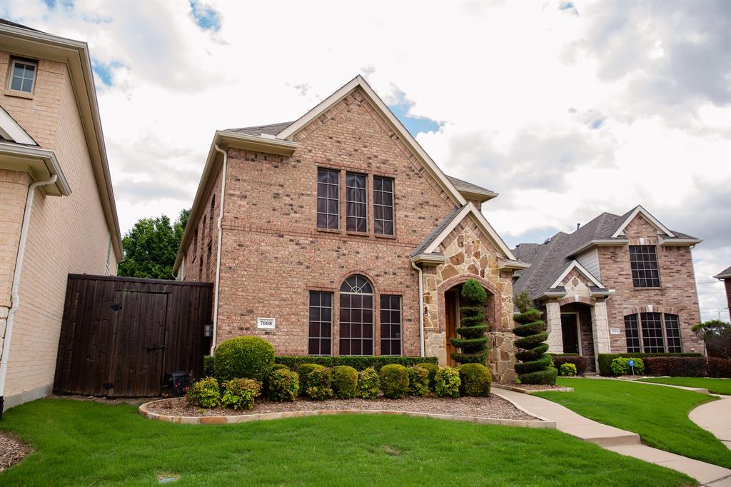 7008 Occidental Road Plano, TX 75025 - Photo 1 of 1 a front view of a house with a garden