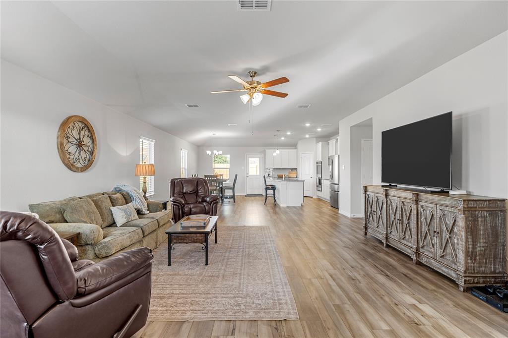 10761 Chesson Flts Drive Waco, TX 76708 - Photo 6 of 30 a living room with furniture and a flat screen tv