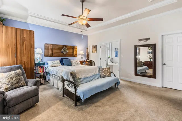 a bedroom with a large bed couch and window