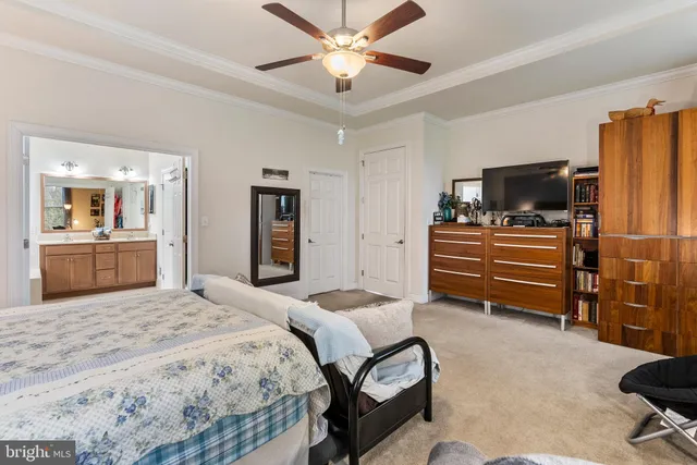 a bedroom with a bed and a television