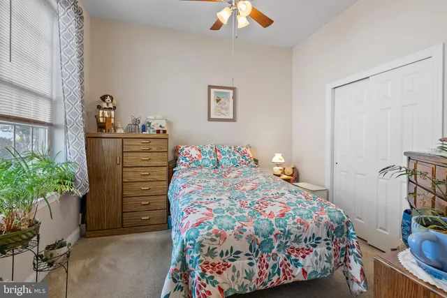 a bedroom with a bed and ceiling fan