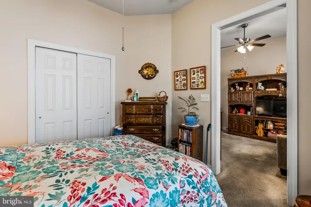 a bedroom with a bed and a bookshelf