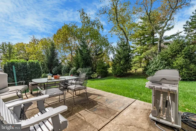 a view of a patio with a table and chairs