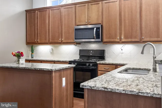 a view of a backyard with couches plants and large trees