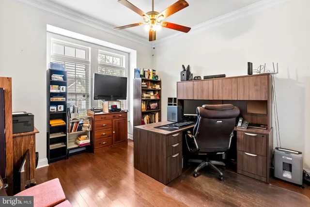 a view of a workspace with furniture and a window