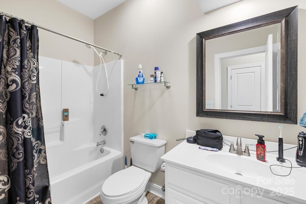 18810 Coachmans Trace Cornelius, NC 28031 - Photo 17 of 30 a bathroom with a sink a toilet and shower