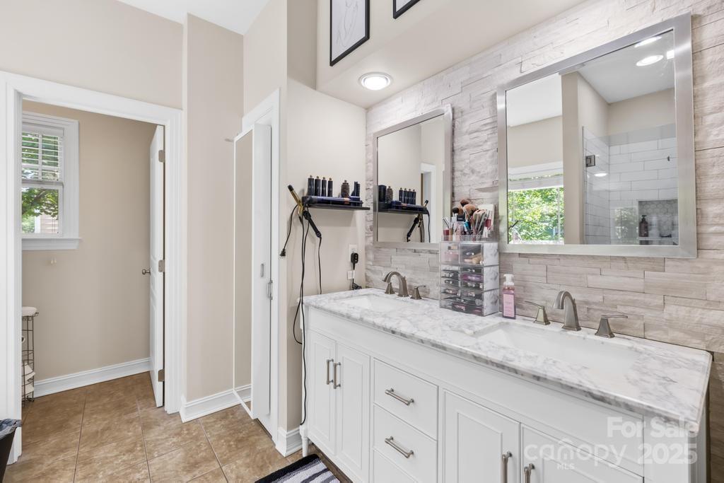 18810 Coachmans Trace Cornelius, NC 28031 - Photo 21 of 30 a bathroom with a granite countertop sink mirror and double