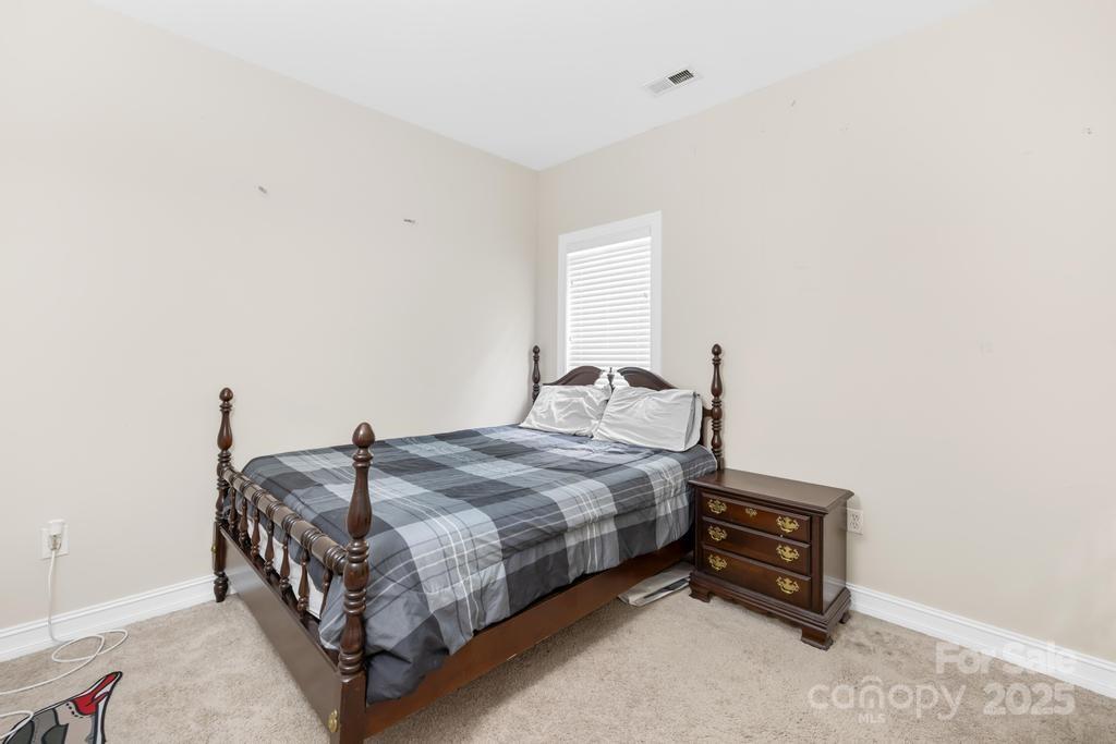 18810 Coachmans Trace Cornelius, NC 28031 - Photo 24 of 30 a bedroom with a bed and a window