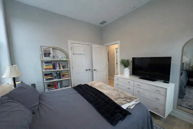 a bedroom with a bed and a flat screen tv