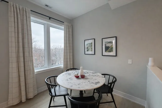 a view of a dining room with furniture and a window