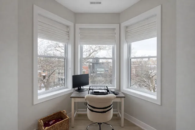 a work room with furniture and windows
